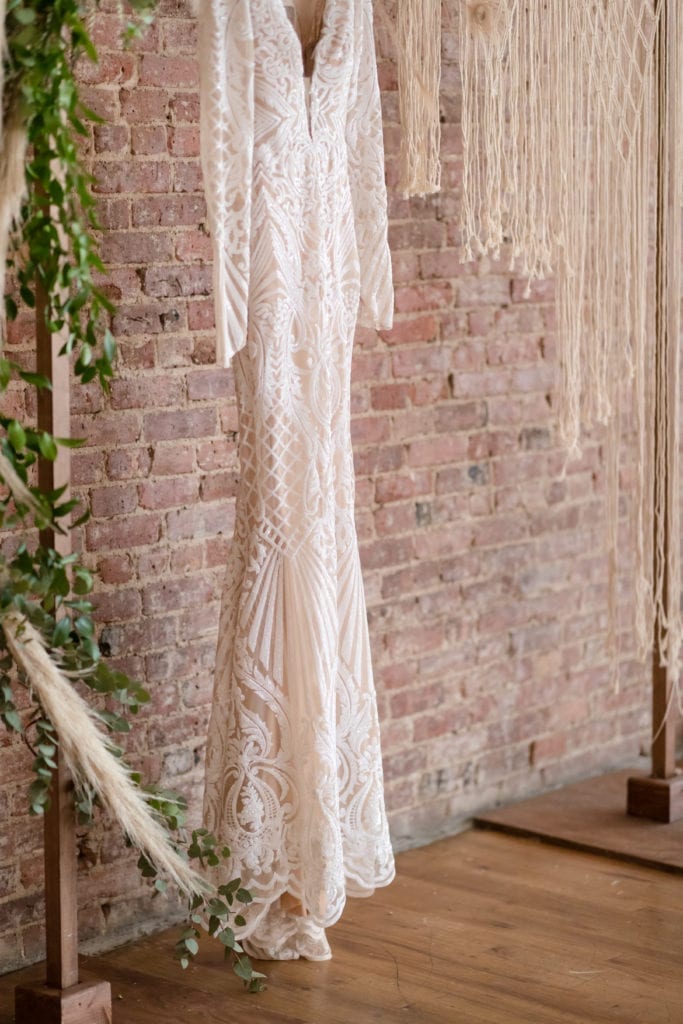 long sleeve lace boho wedding dress, hanging lace wedding dress photography