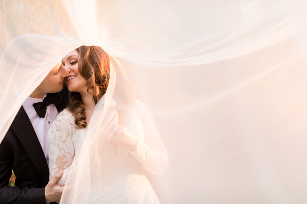 bride and groom creative veil photo. Photo by Vanessa Joy Photography.