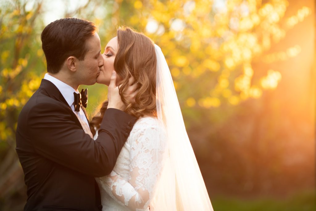 bride and groom kissing during golden hour. Photo by Vanessa Joy Photography