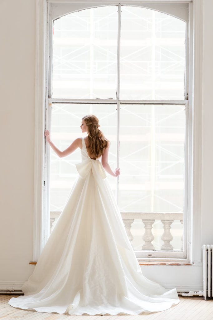 bride on large window balcony. Photo by Vanessa Joy Photography