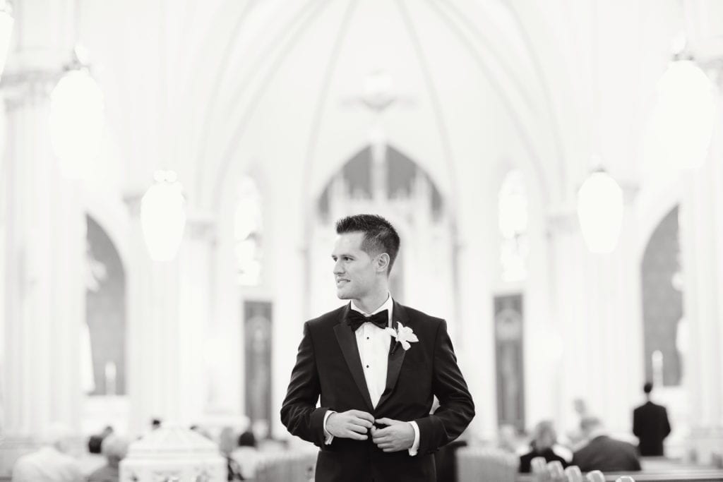 groom, black and white wedding photography, groom in church, hugo boss tuxedo