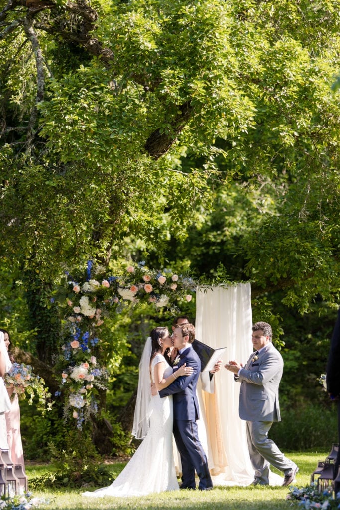 first kiss bride and groom, elegant garden wedding