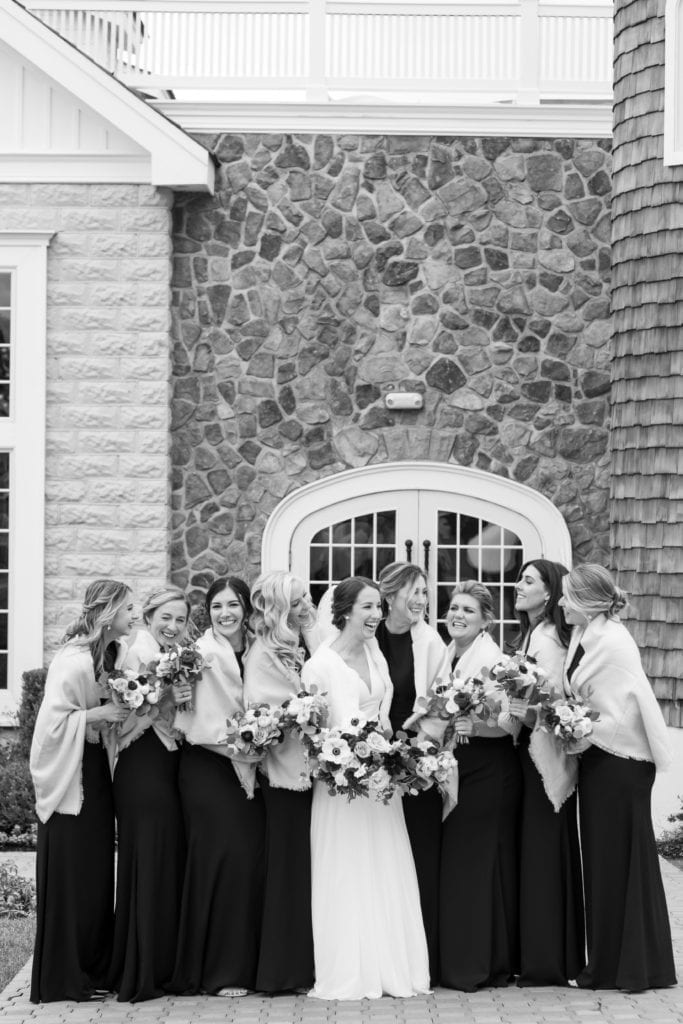 black and white photo of bride and her bridesmaids in their fur stoles