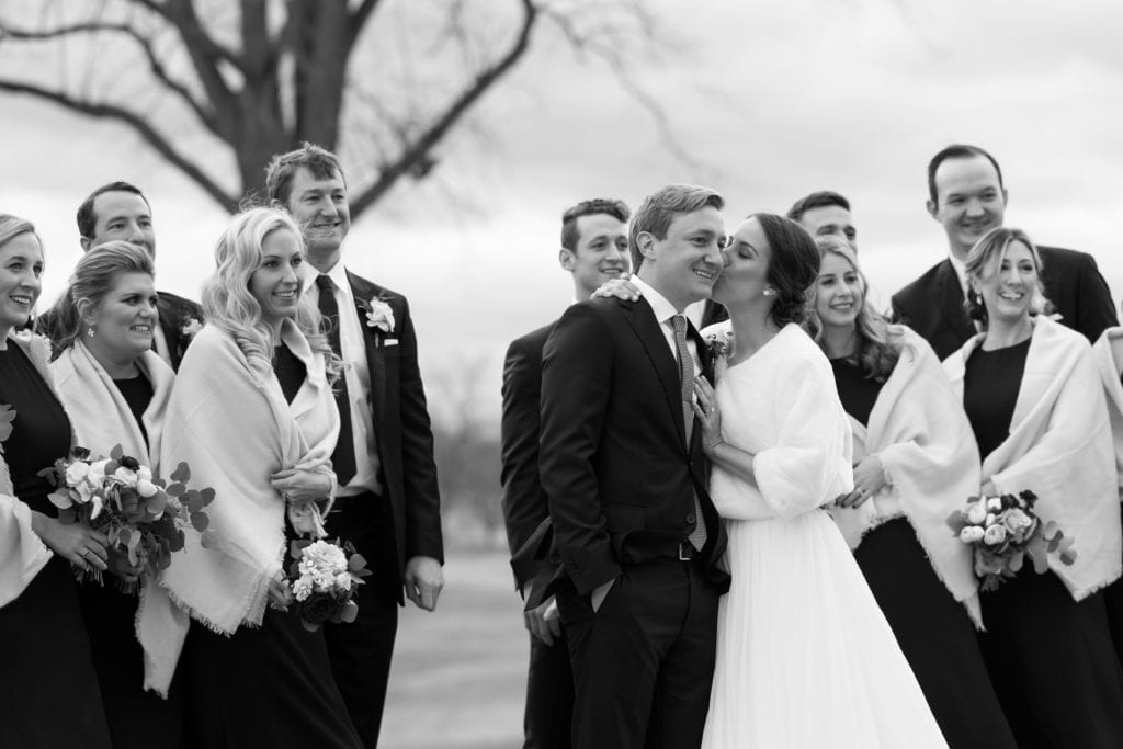 bride and groom in a black and white wedding photo with their wedding party