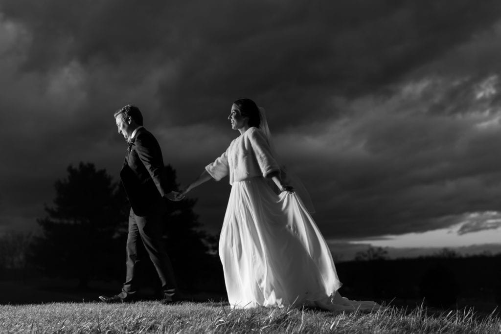 Bride and groom walking across the countryside at Fiddler's Elbow countryclub