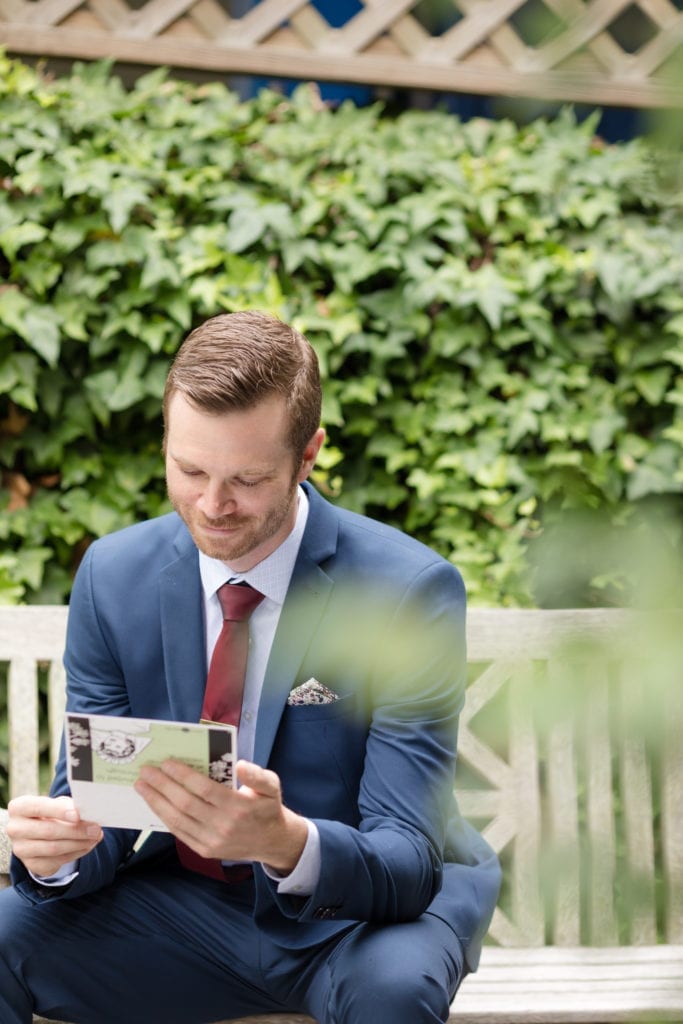groom reading his letter from his bride