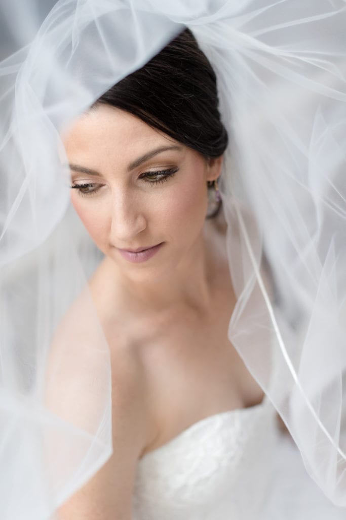 up close photo of bride with her veil flowing