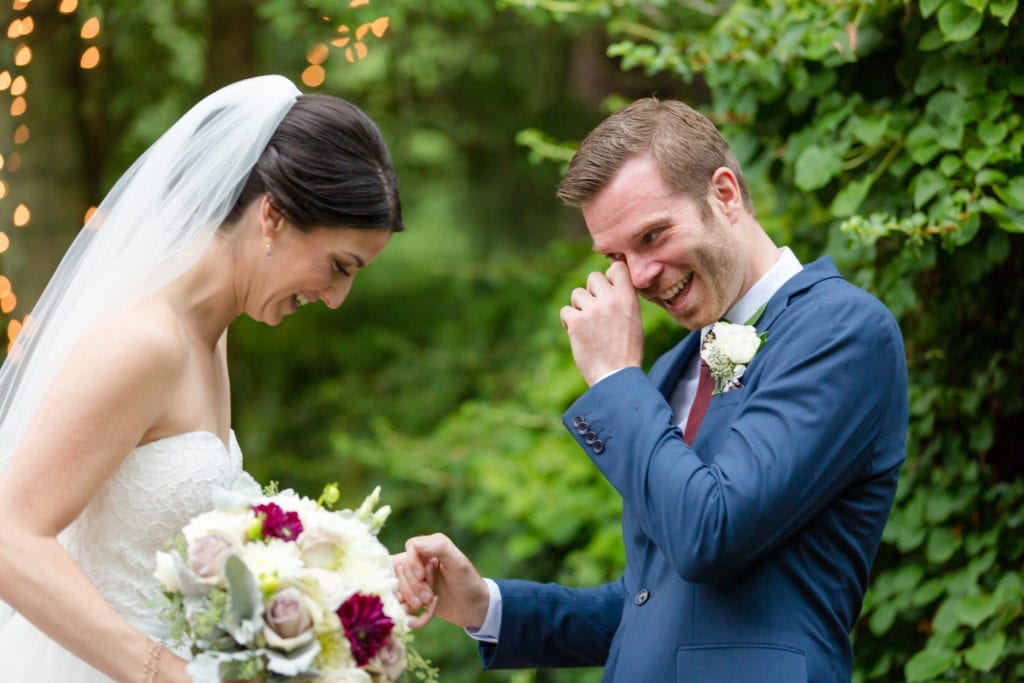groom crying as he sees his bride