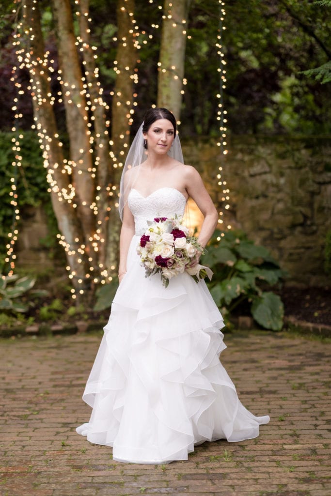 bride in her mikaella bridal dress with her magnificent florals