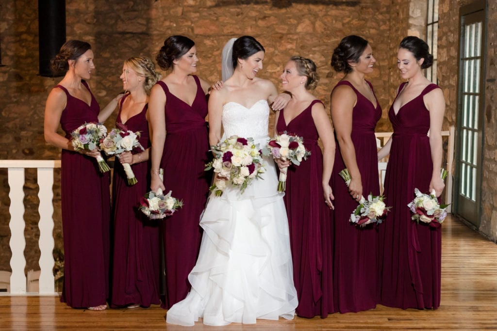 bride with her bridesmaids in their maroon dresses
