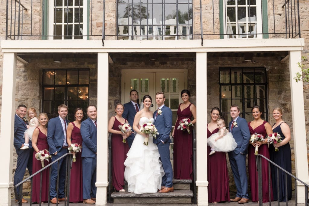 bride and groom with their bridal party outside of wedding venue