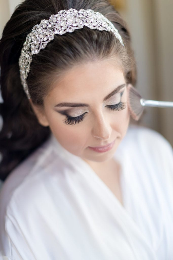 detail shot of brides makeup and her diamond encrusted hair piece from Bridal Styles Boutique