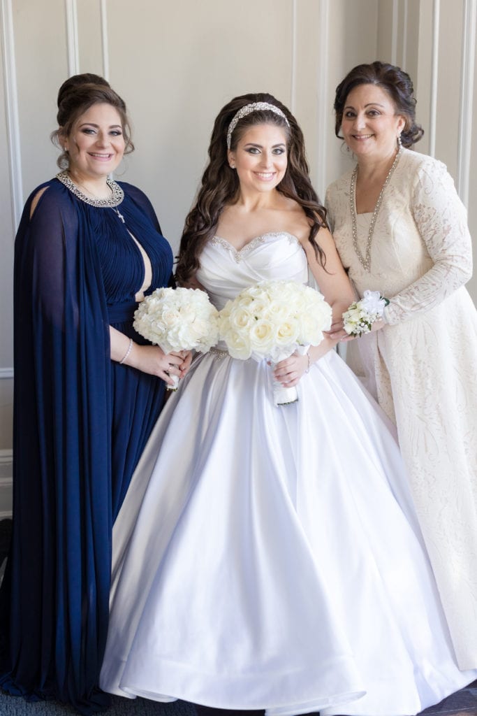 bride posing in her Pnina Tornai with her mother and maid of honor