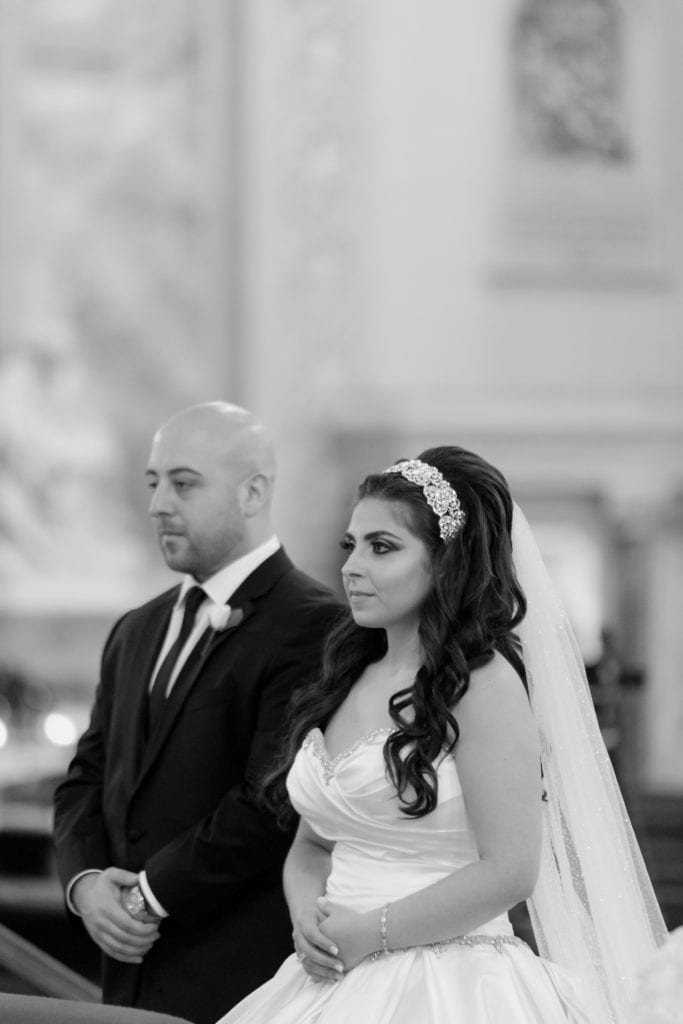 black and white photo of bride and groom at wedding ceremony