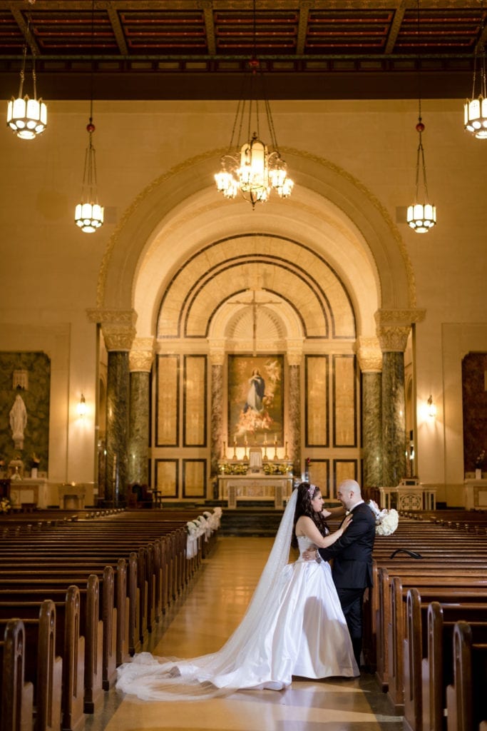 bride and groom in their church posing for a picture
