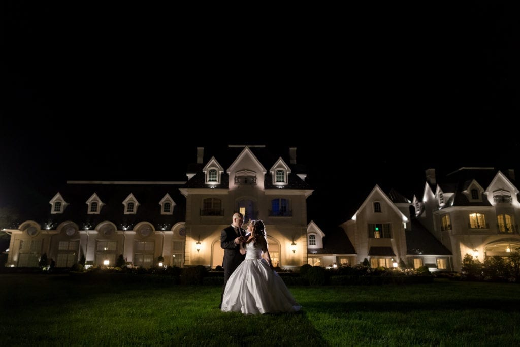 Night time shot of bride and groom outside of Park Chateau 