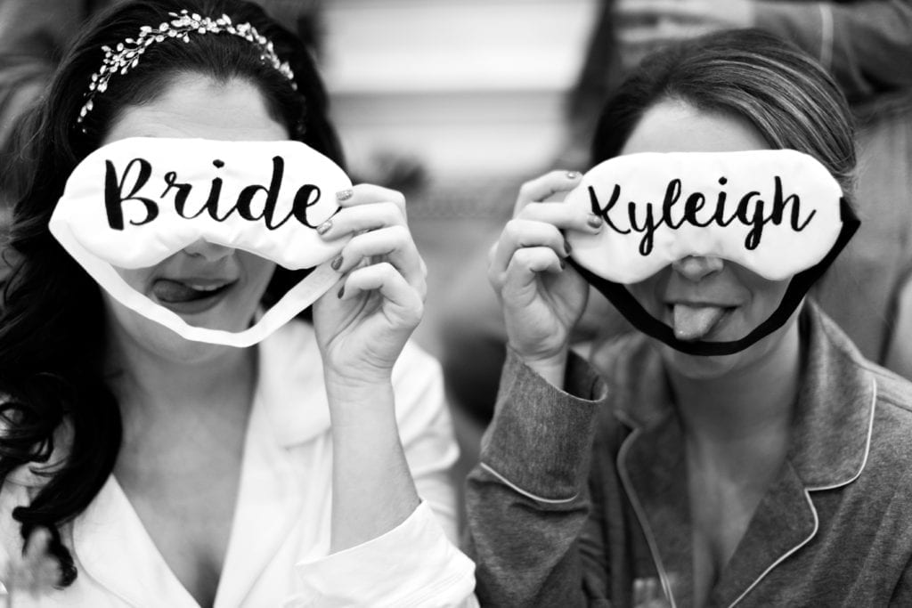 bride and bridesmaid making funny faces with sleep masks