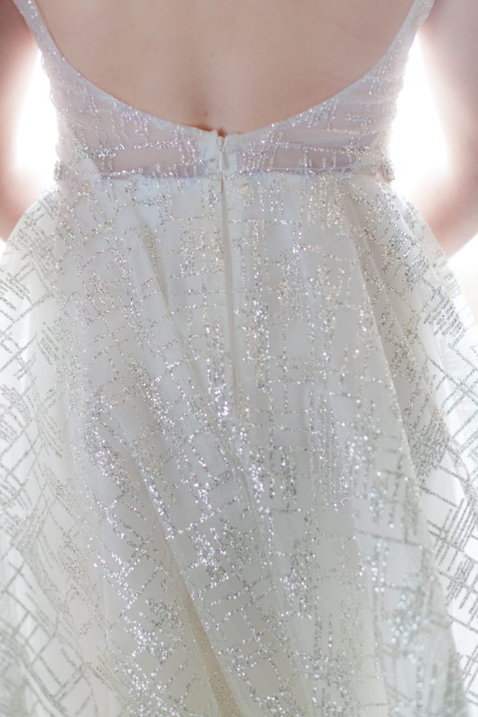 detail shot of brides silver beaded Lazaro wedding gown