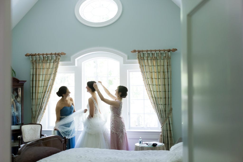 mother of bride putting on her veil, bride getting ready