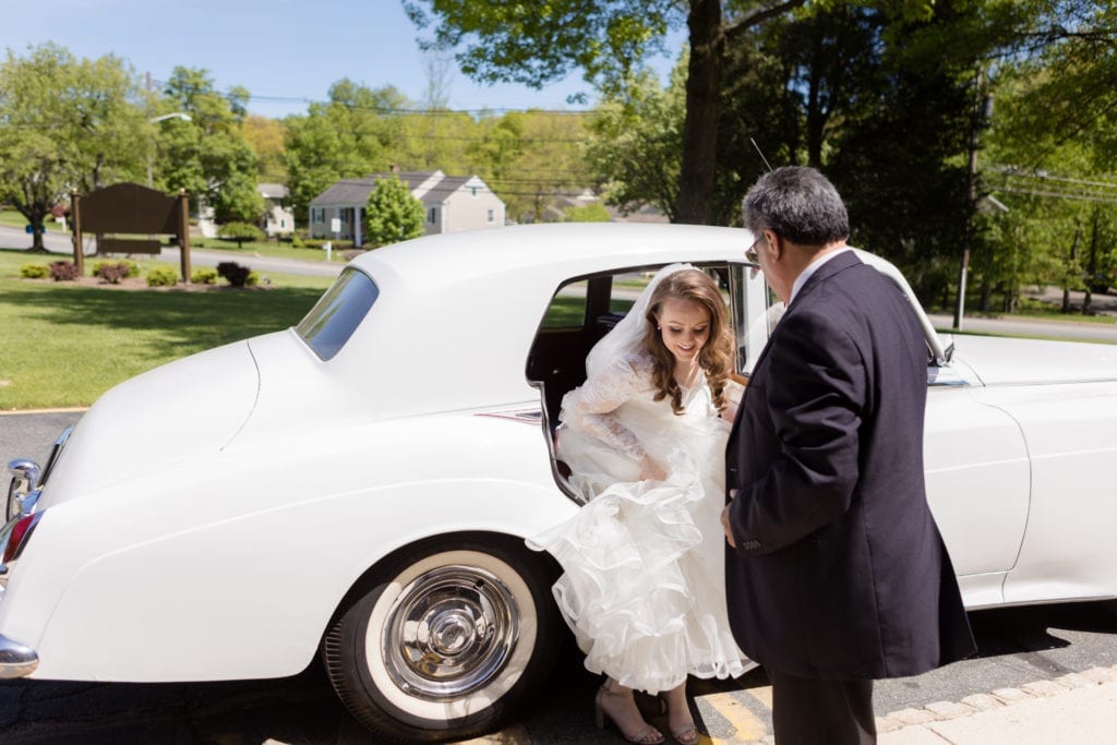 brides father helping her out of car