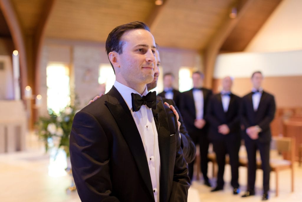 groom awaiting the arrival of his bride at the alter