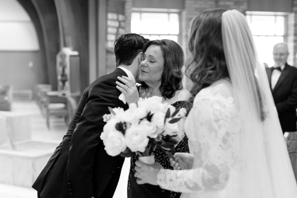 groom greeting the brides mother, black and white wedding photographer