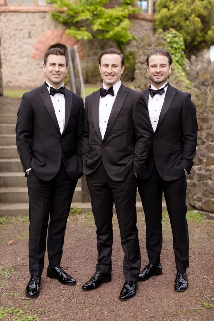 groom with his brother, black and white wedding tuxedos