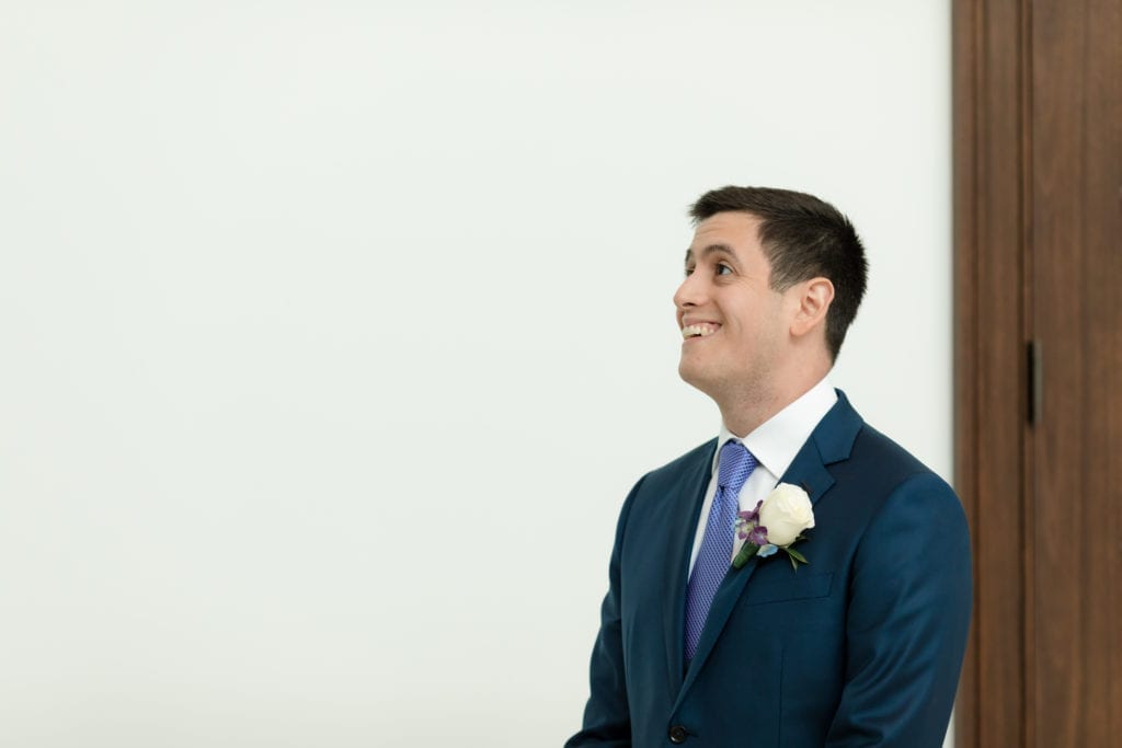 groom seeing his bride for the first time, navy wedding suit