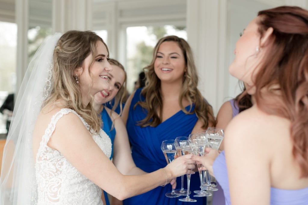 bride sharing champagne with her bridesmaids, bride and bridesmaids