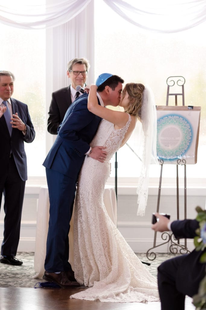 bride and grooms first kiss, Jewish wedding ceremony