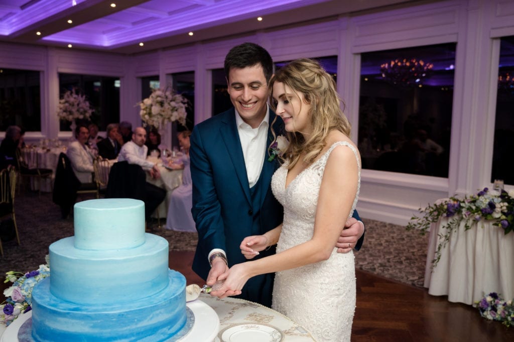 bride and groom cutting the cake, blue 3 tiered cake