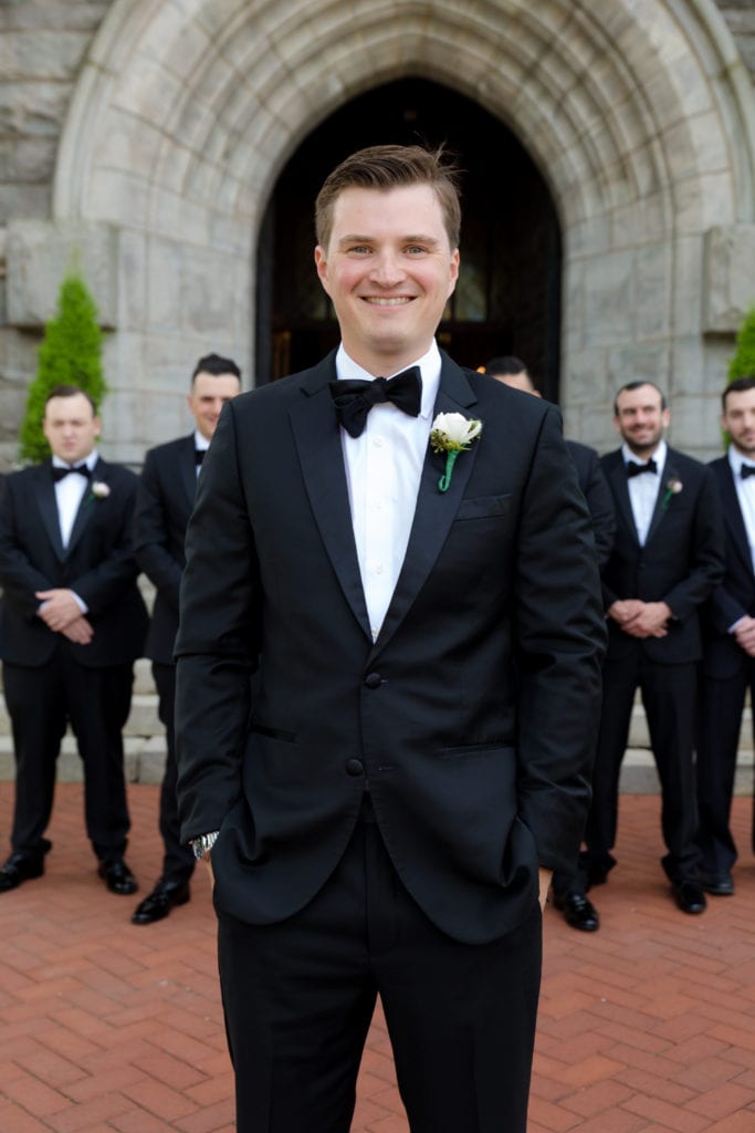 groom in the forefront of his groomsmen