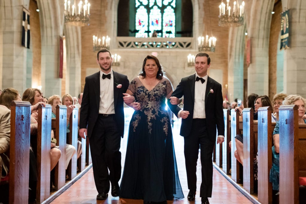 mother of the groom with her sons. entrance to wedding