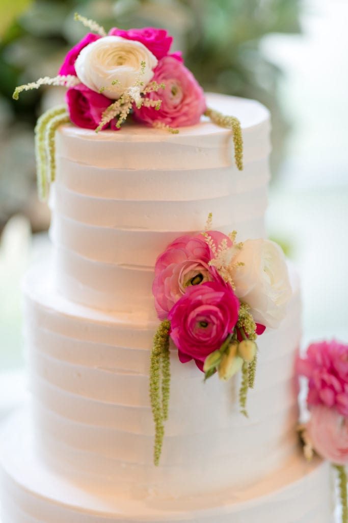 bright pink florals on wedding cake