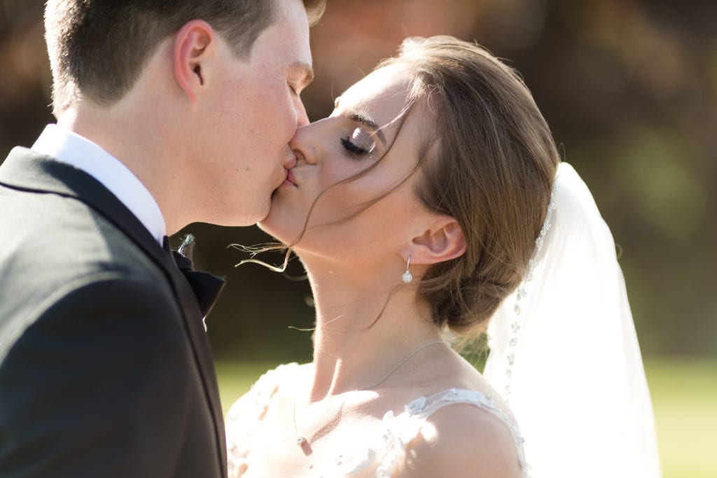 close up of bride and grooms kiss