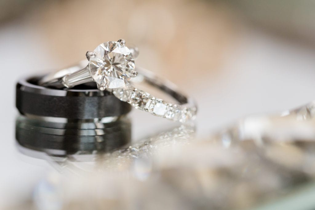 round diamond engagement ring, black wedding band