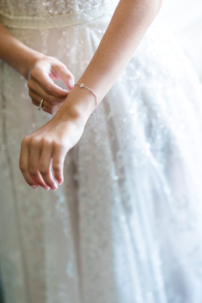 bride putting on her diamond bracelet, brides bracelet from bloomingdales