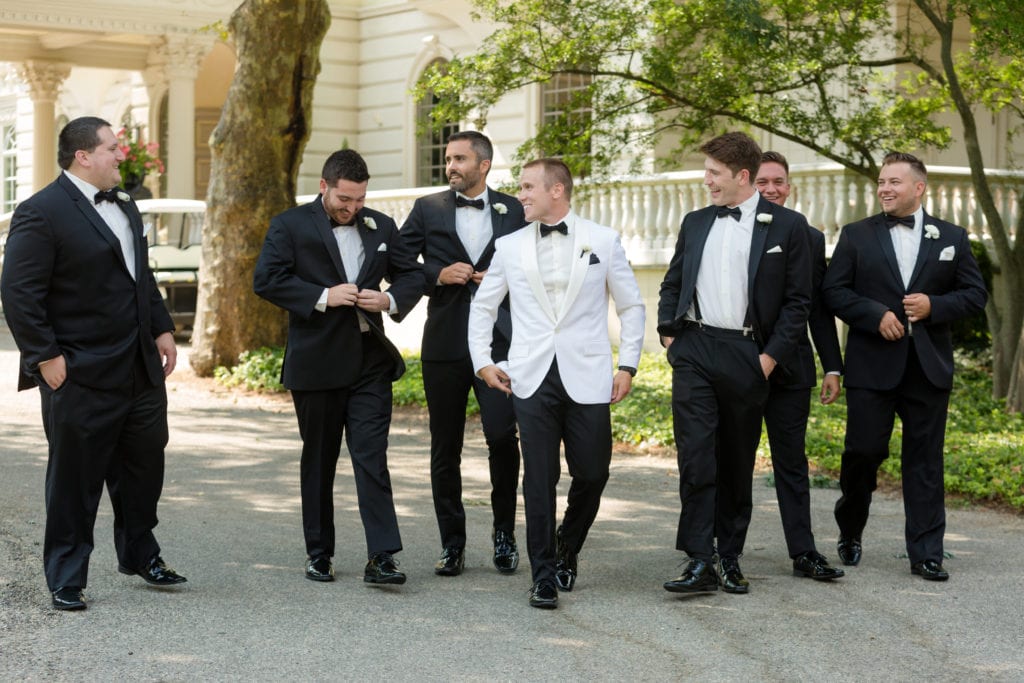 groom sharing a laugh with his groomsmen, Mens wearhouse suits