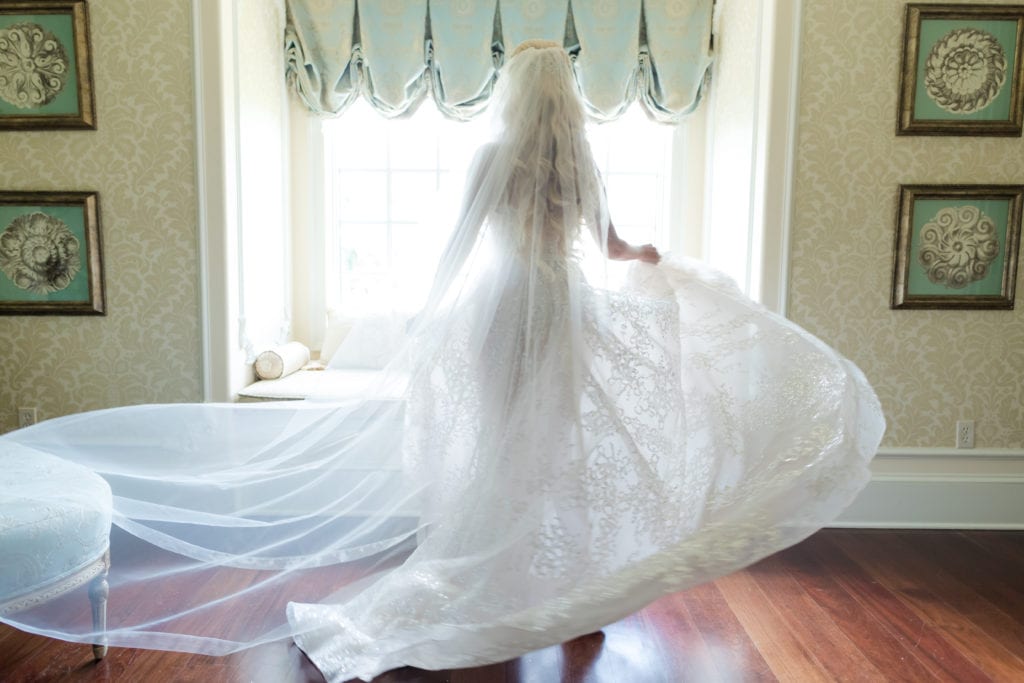 bride twirling in her berta gown and veil