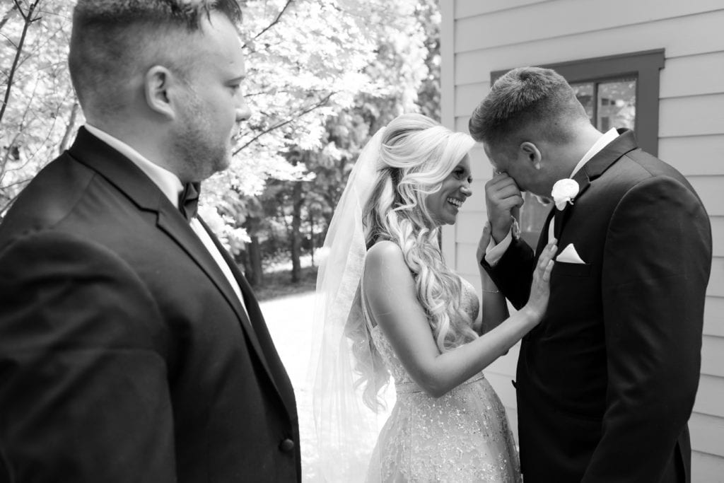 groom shedding a tear with his bride