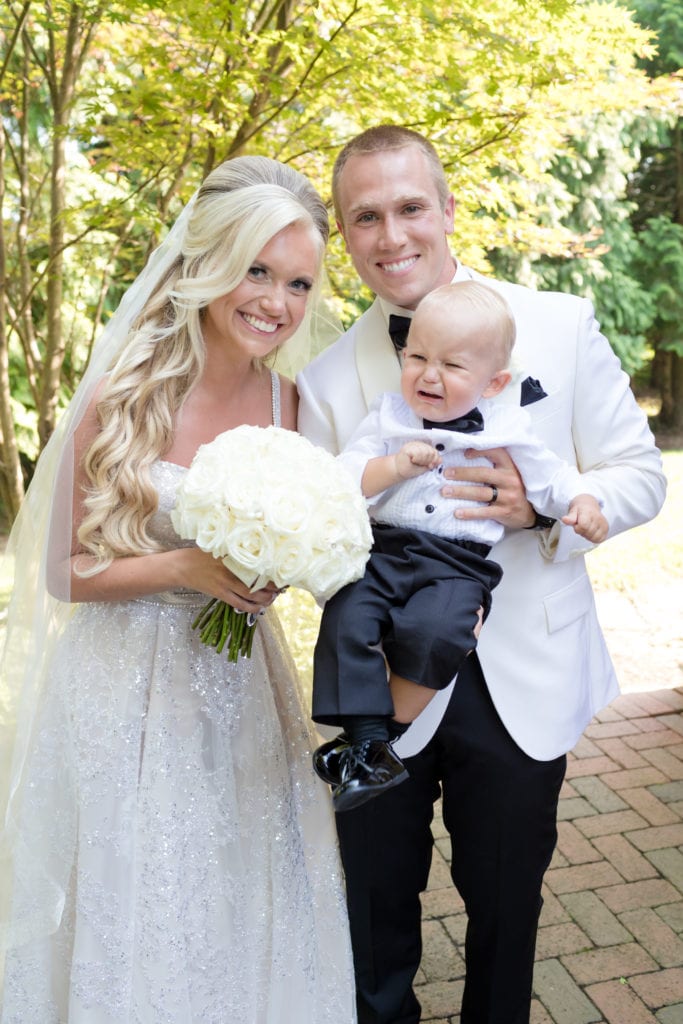 bride and groom with baby