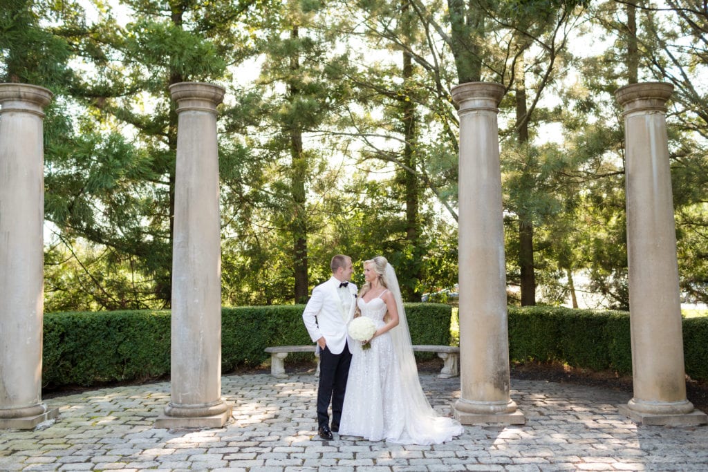 bride and groom with columns at Ashford Estate