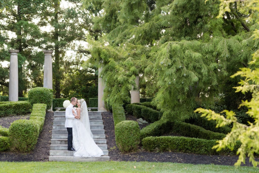 bride and groom kissing in garden, nj wedding photographer