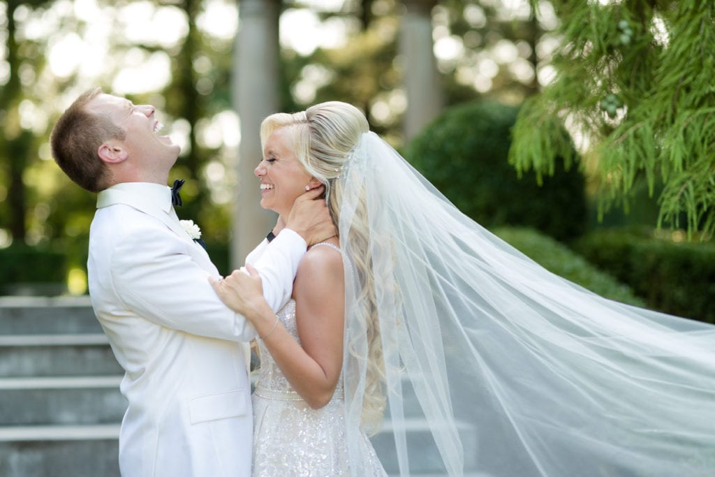 bride and groom sharing a laugh, berta bridal veil