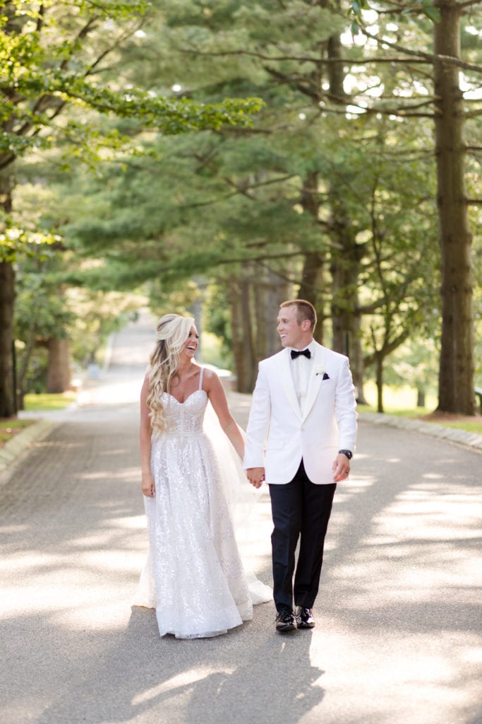 bride and groom share a moment walking, bride and groom wedding photography