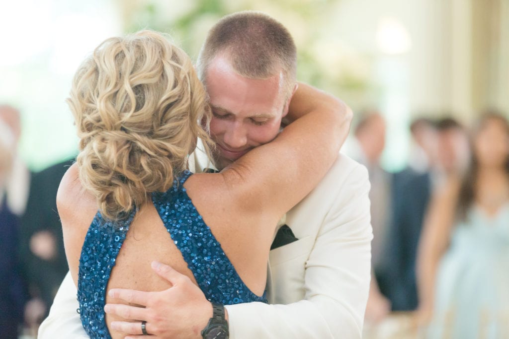 groom embraces his mother