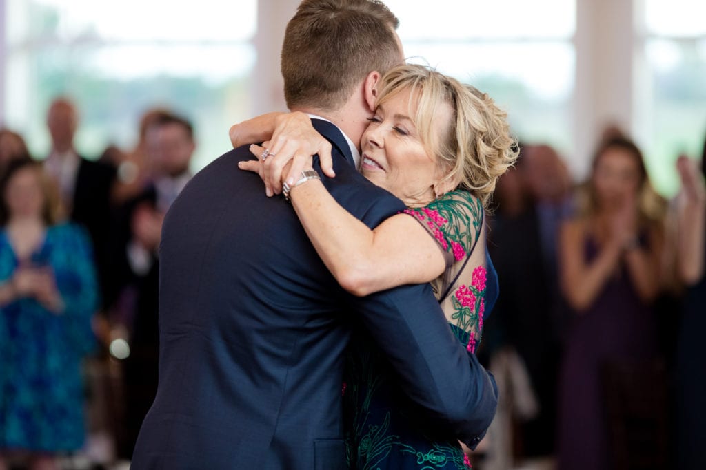 mother of groom embracing her son