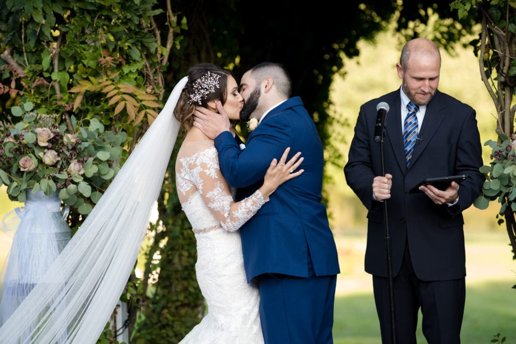 bride and grooms first kiss, wedding day kiss