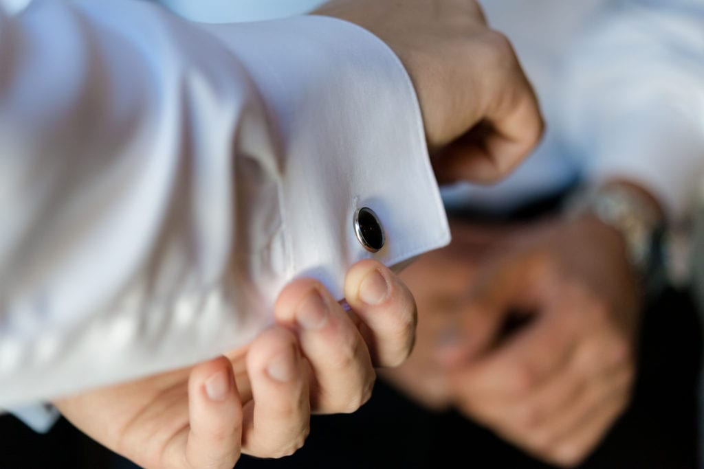 groom putting on cufflinks, wedding cufflinks