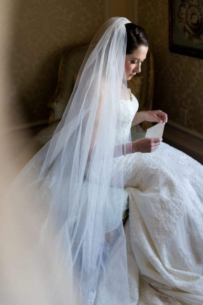 bride reading letter from groom on her wedding day